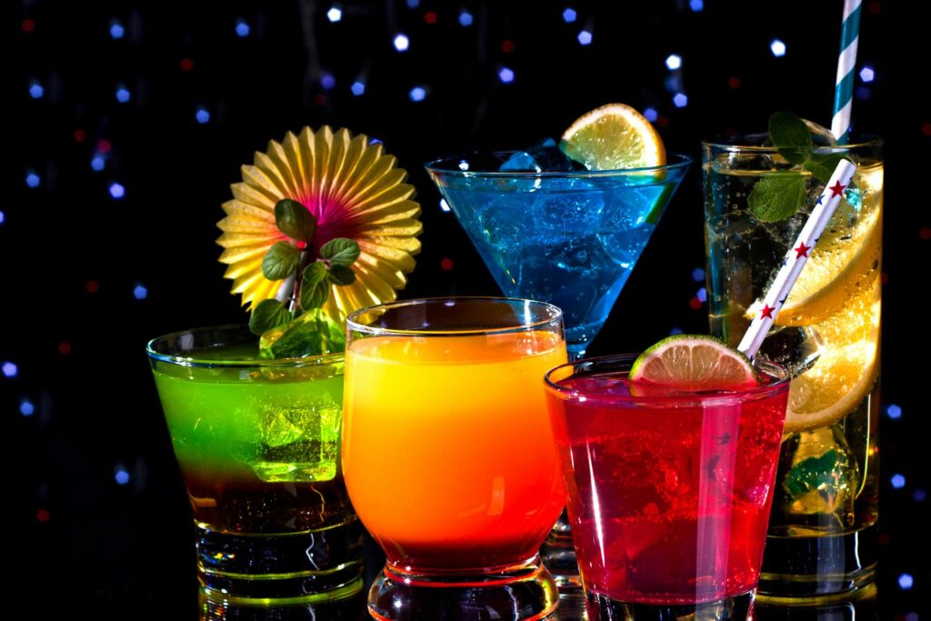 Magic Potions for the Soul - colorful cocktails served side-by-side with a dark background