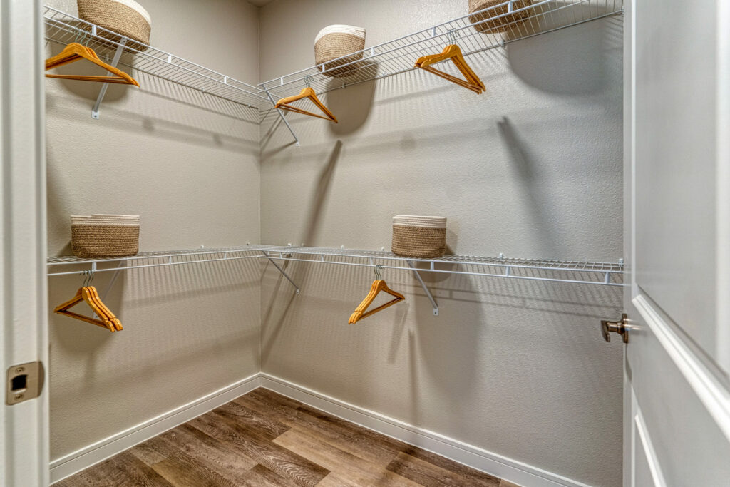 Touched by a Bit of Luxury - luxurious and spacious walk-in closet with metal shelves and hangers
