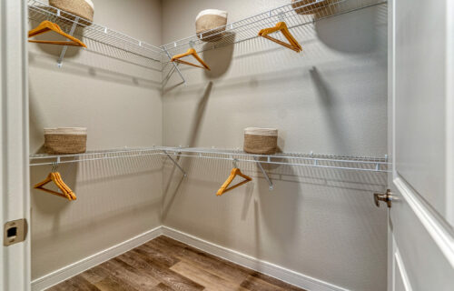 Touched by a Bit of Luxury - luxurious and spacious walk-in closet with metal shelves and hangers